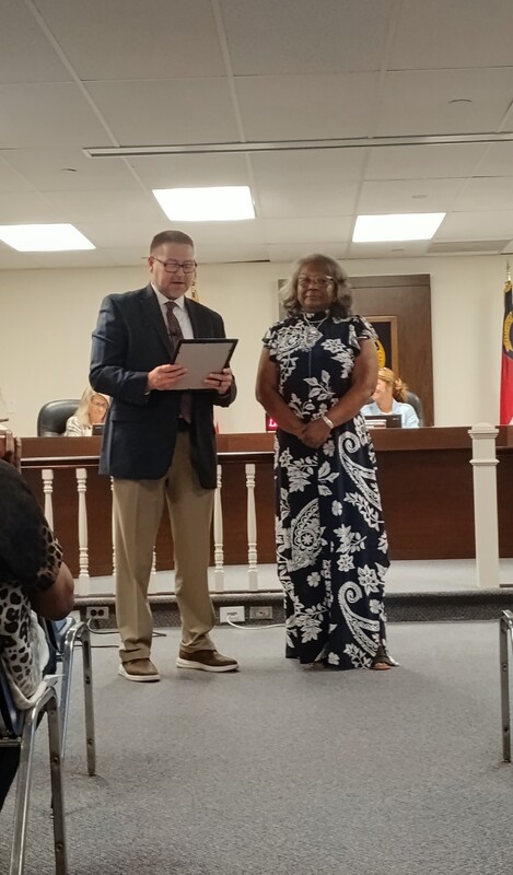 Dr. Perkins presents award to Ms. Young.