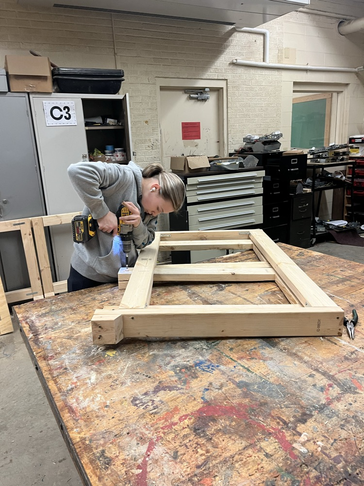 Lauren Neece working on finishing up the legs of the table