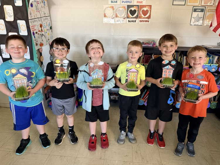 students holding up their projects