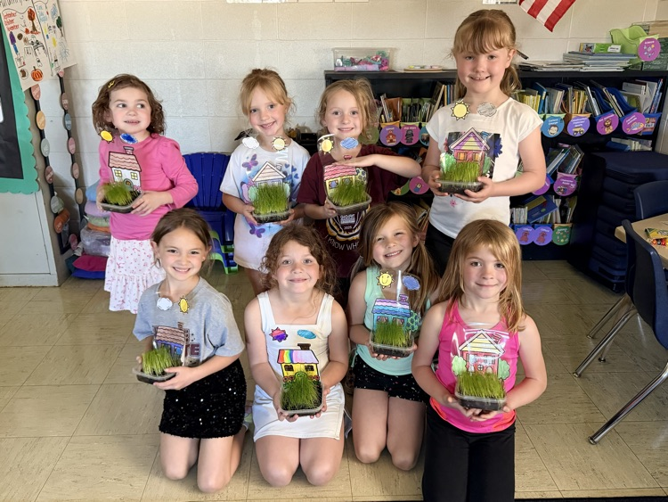 students holding up their projects