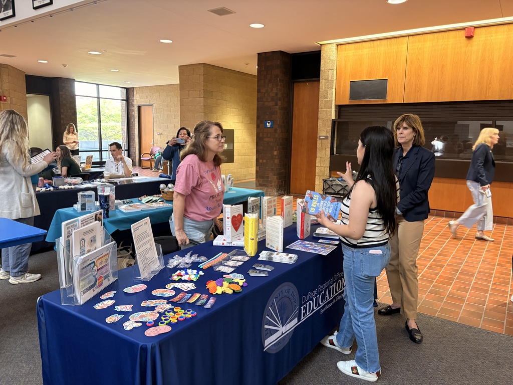 people standing at book table