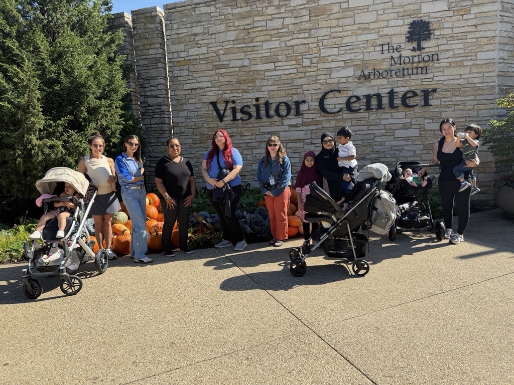 Group of people with strollers and pumpkins at the visitor center of The Morton Arboretum.