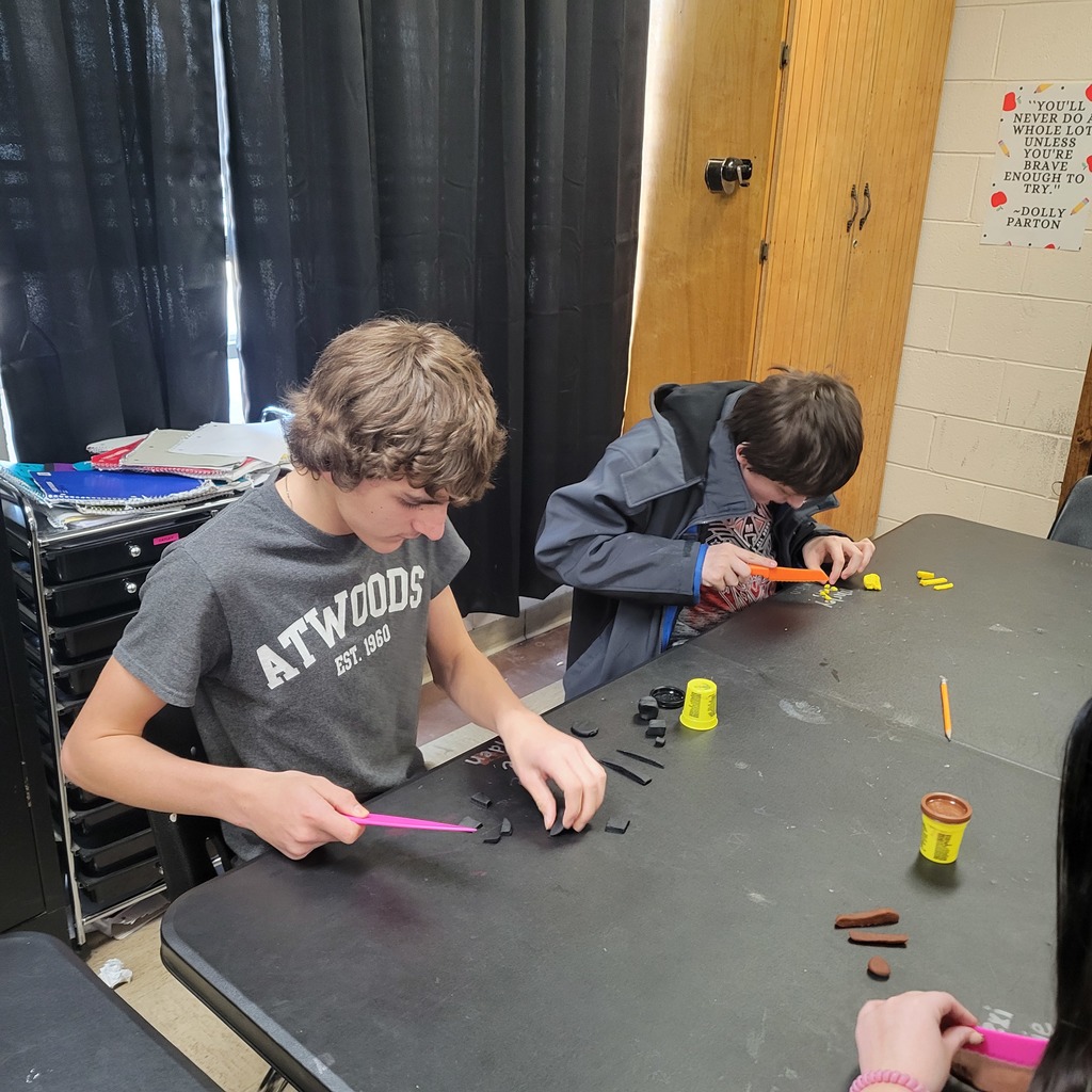 Roland Middle School students in Home Economics class practicing knife safety skills. Students are using plastic knives and Play-Doh to practice different cutting techniques while learning about proper knife handling and kitchen safety.