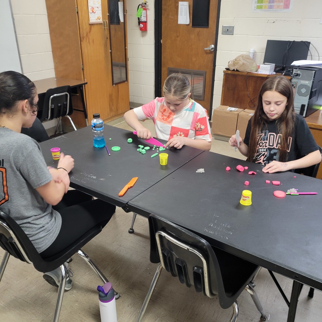 Roland Middle School students in Home Economics class practicing knife safety skills. Students are using plastic knives and Play-Doh to practice different cutting techniques while learning about proper knife handling and kitchen safety.