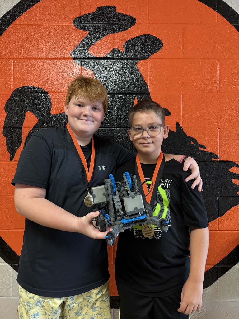 Two students holding a robot 