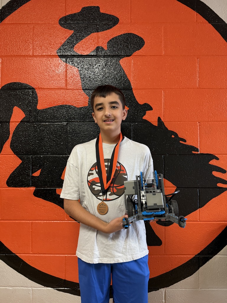 one student holding a robot 