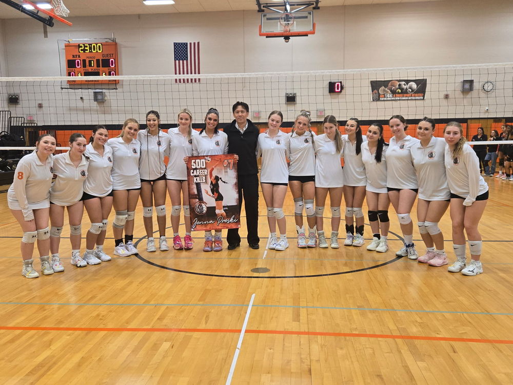 The RFA girls volleyball team celebrates  Jenna Preski hitting 500 kills this season.