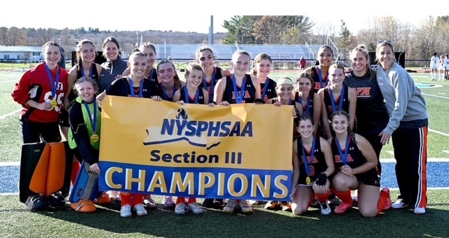 The Rome Free Academy Field Hockey Team pose with the NYSPHSAA Section III Championship banner after winning the title.