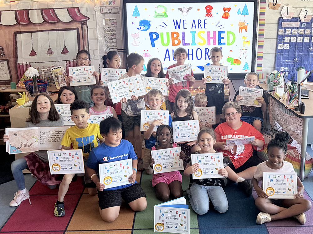 Bellamy Elementary students smile and pose with their published books.