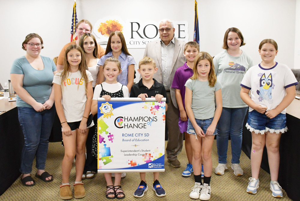 The Superintendent's Student Leadership Council is presented with the NYSSBA Champions of Change Recognition banner.