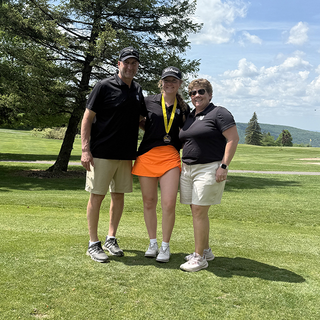 Rachel O'Rourke, center of the photo, poses with Head Coach Dave Petrelli, left, and Assistant Coach Milessa O'Rourke, right after capturing the NYSPHSAA Girls Golf Section III Championship.