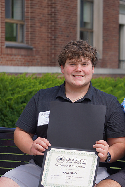 RFA senior Noah Riolo poses with a Certificate of Completion following the Le Moyne Leadership Academy.