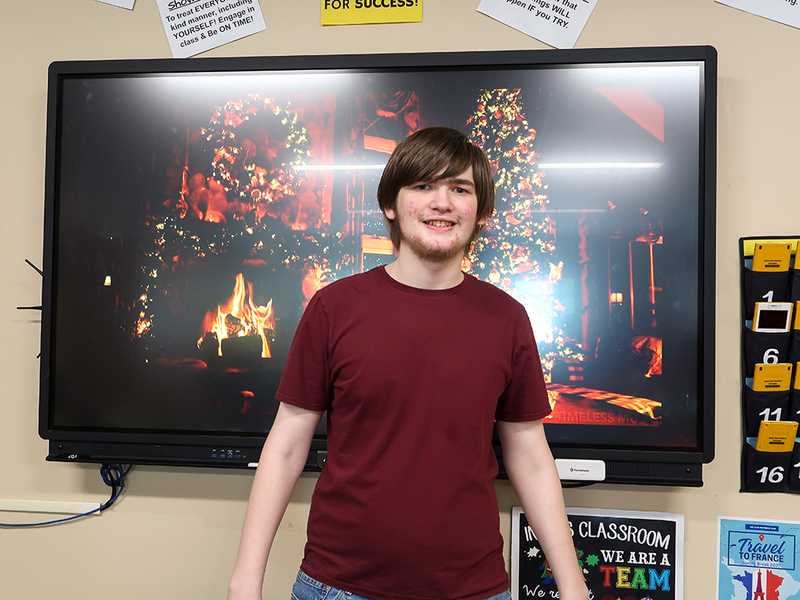 RFA student Seth Briggs serves as the DJ during a holiday party.