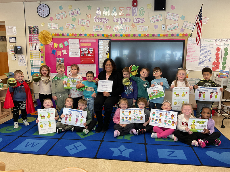 Clough Pre-K School Counselor Tina Campos with students in the Early Childhood Program.