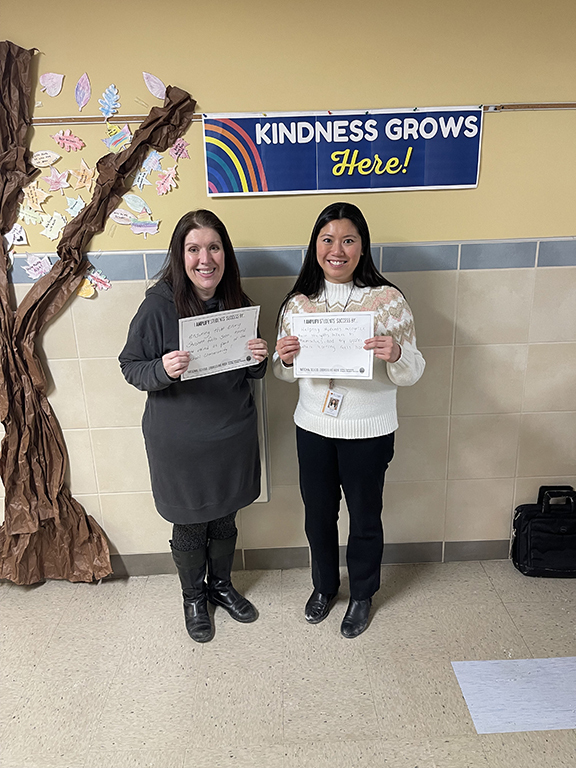 John Joy Elementary School Counselors Rebecca Roberts (left) and Madison Usyk (right) pose with their National School Counseling Week signs.