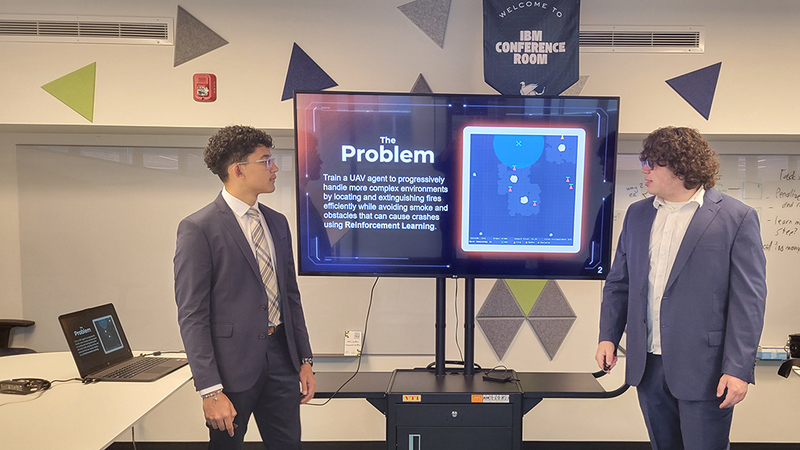 RFA senior Elijah Pomales, left,  and senior Timothy Hill, right, present their solution during  the 2026 AFRL Challenge Competition.