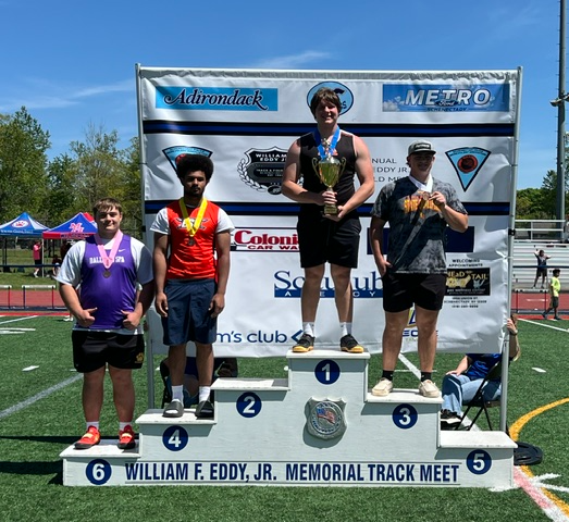 RFA junior Jacob Ciccone stands atop the podium after placing first in the discus and shot put events at the William F. Eddy Jr. Memorial Track Meet