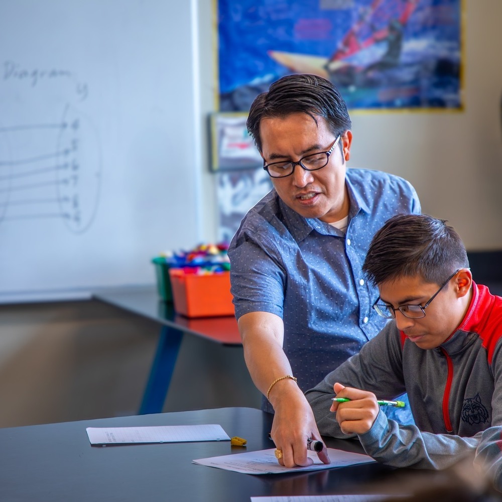 A teacher helps a student during the summer math academy