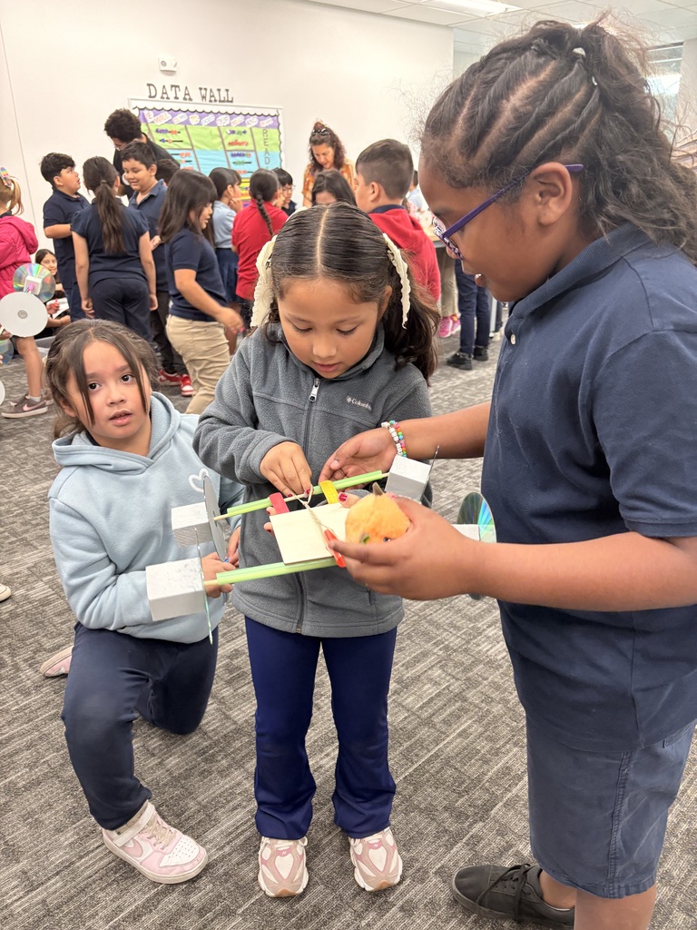 Students building rubberband cars