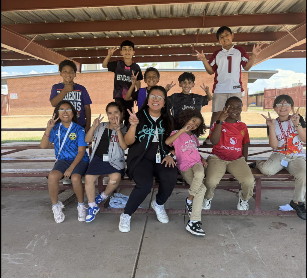 Ms. Williams and students posing in Jerseys