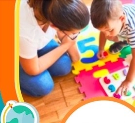 Woman wearing jean pants and white short sleeved shirt and a ponytail, kneeled down with a young boy weaing a striped short sleeved shirt. they are playing with numbers on a colorful foam pad.