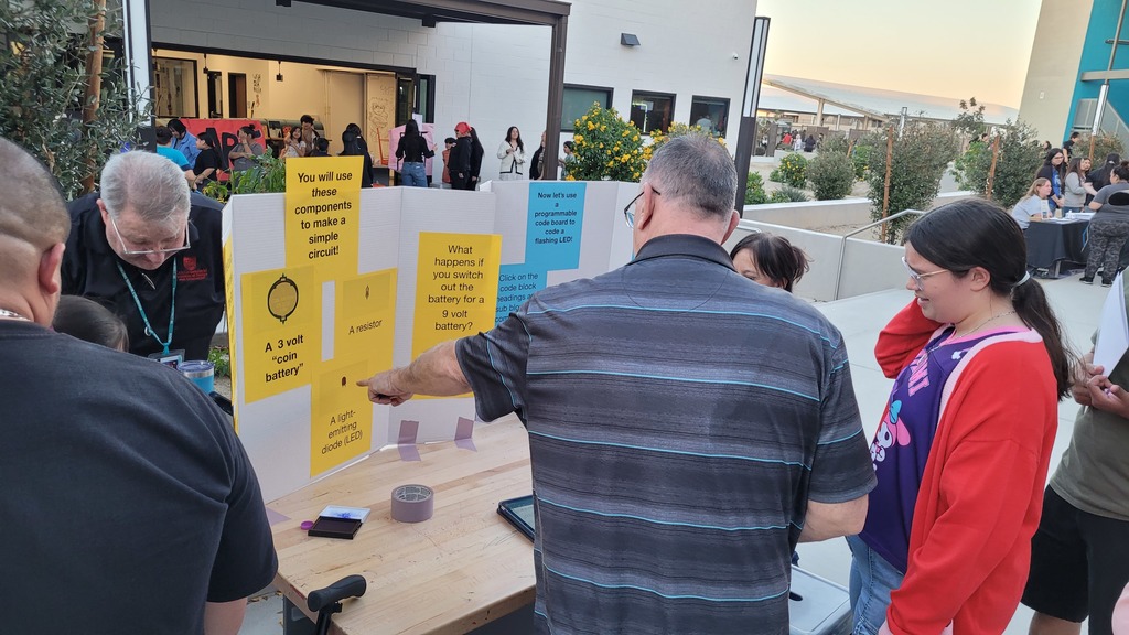 Teachers teaching how to make an electric circuit