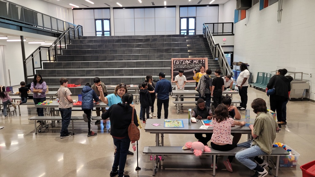 Teachers and families playing board games.