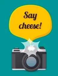 Green background with a yellow bubble with the words "Say Cheese" inside the bubble. Black and white camera