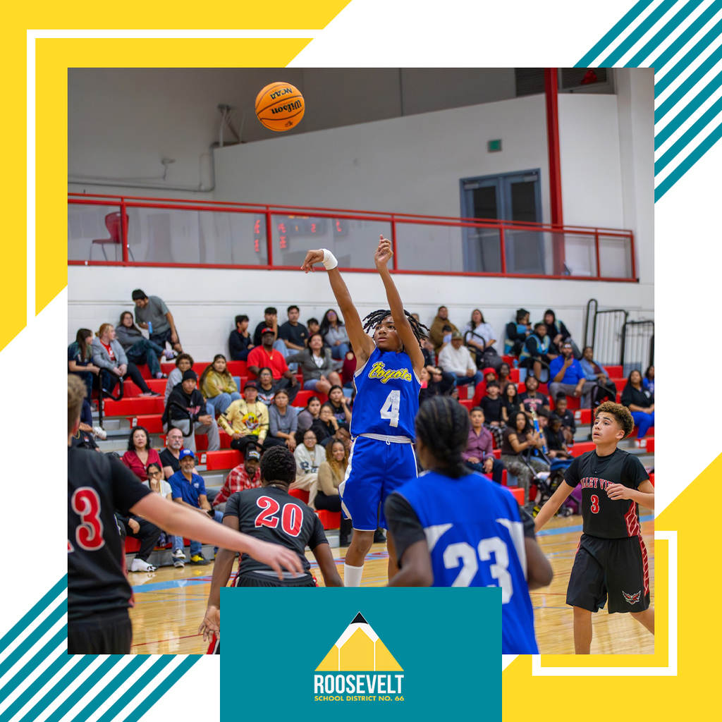 Two teams of Jr High male students playing basketball in a gym.