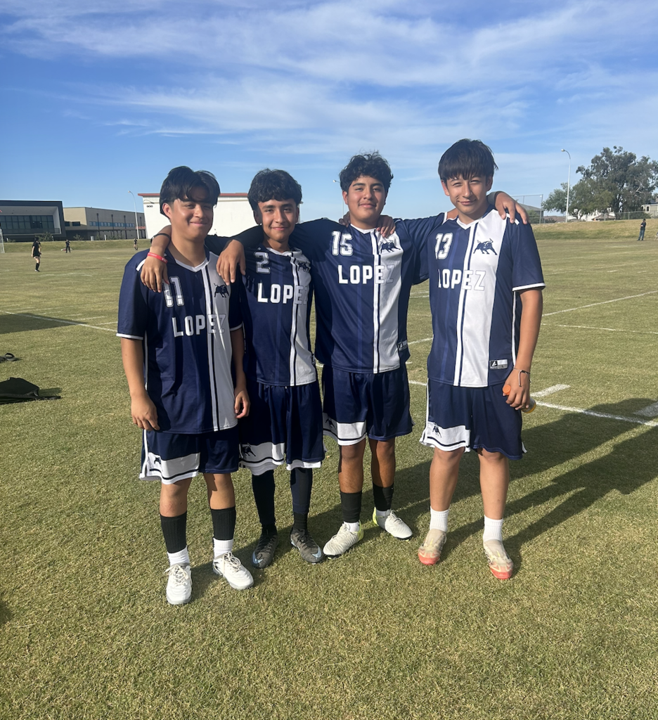 4 Lopez Athletes celebrating their win.
