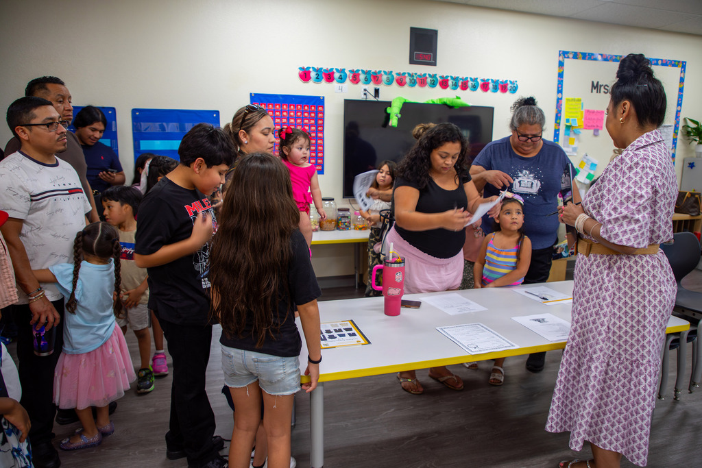 People standing inside of a classroom