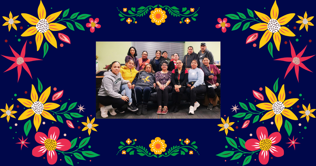 Families sitting together surrounded by colorful garden of flowers