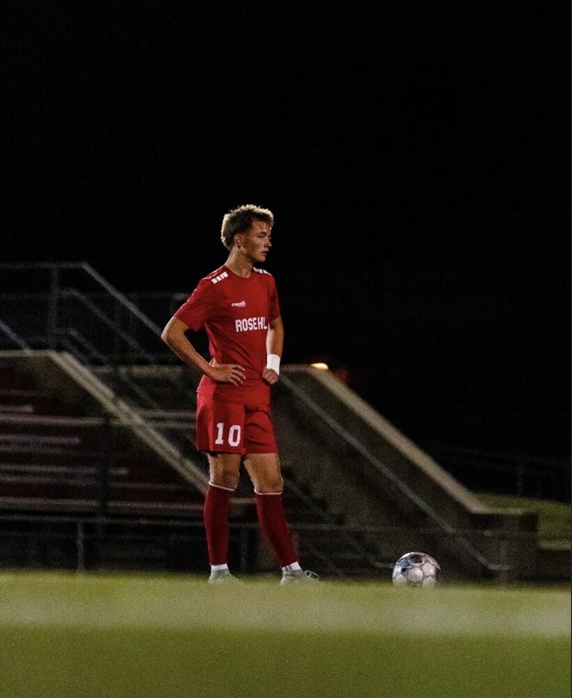 Brady Liebl, Rose Hill soccer jersey number 10, stands on the field waiting for the signal to kick the ball into play.