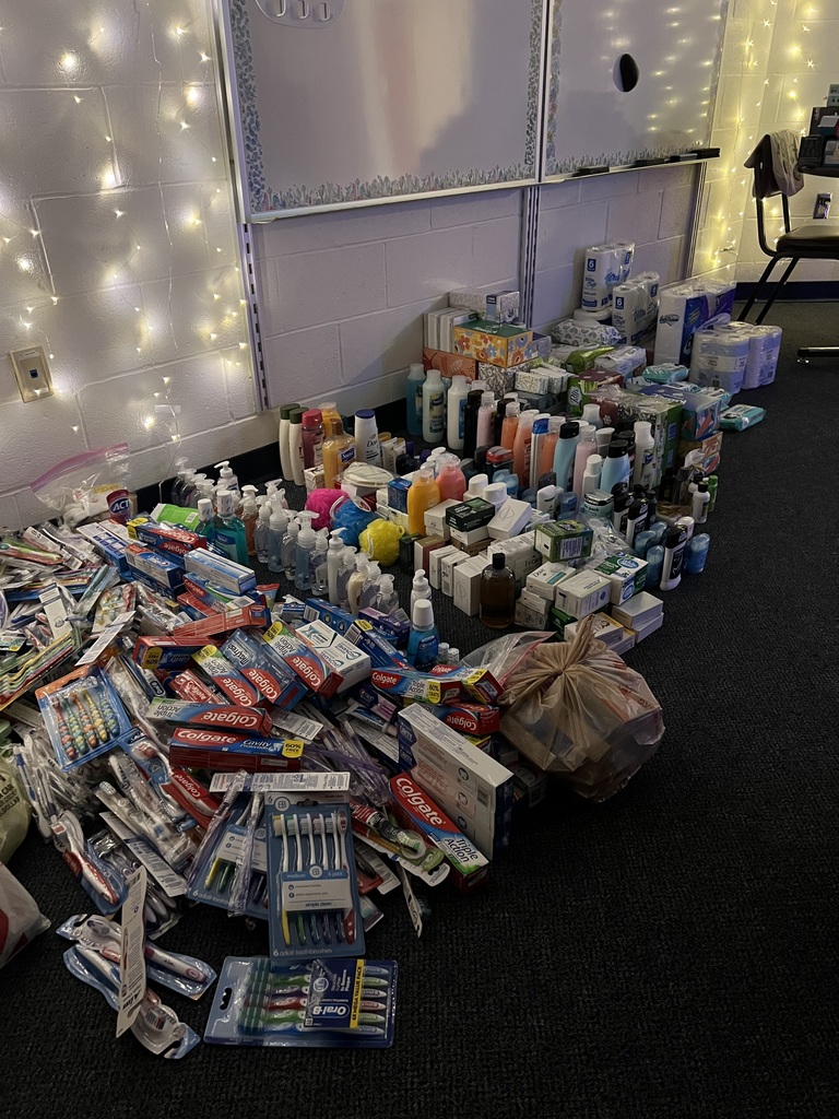 mounds of toothbrushes, toothpaste, and toilet paper