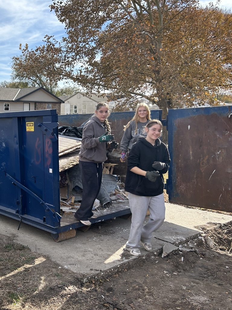 KAY Club students working with Habitat for Humanity - throwing away old debris