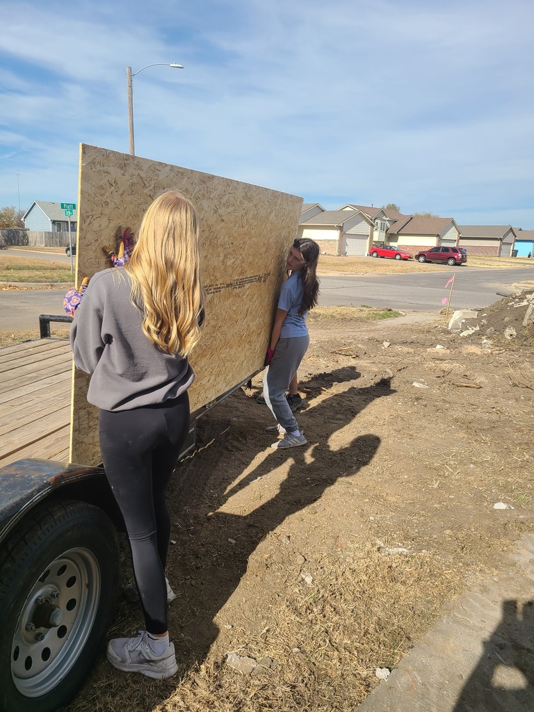 KAY Club students working with Habitat for Humanity - lifting plywood