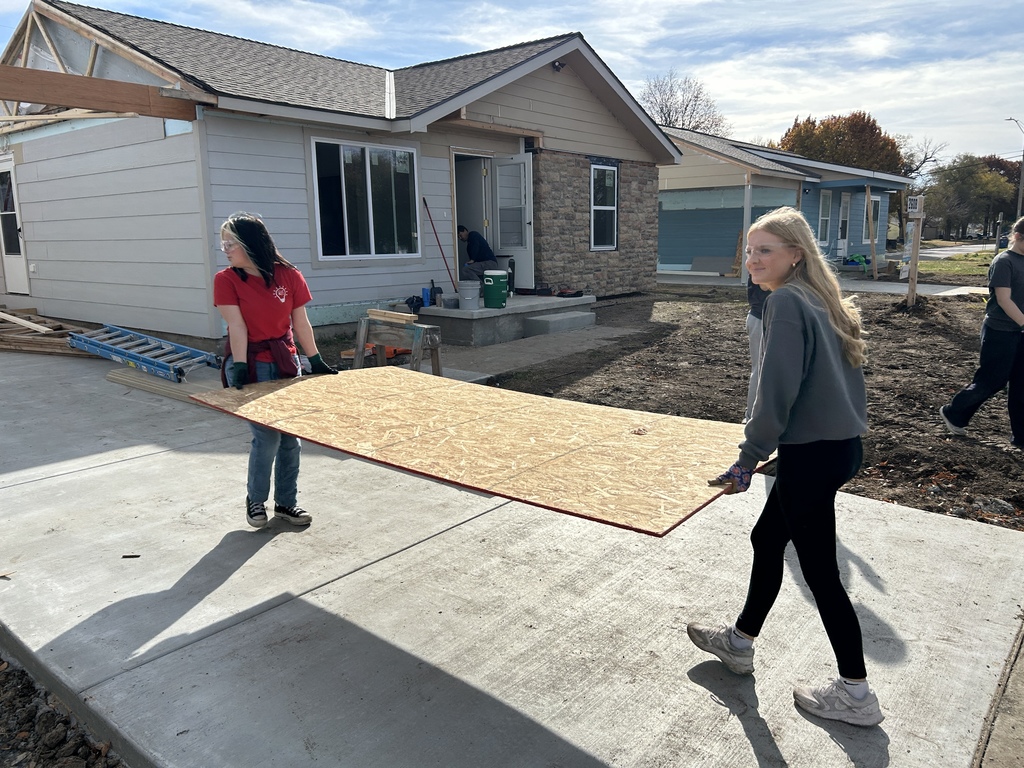 KAY Club students working with Habitat for Humanity - carrying plywood