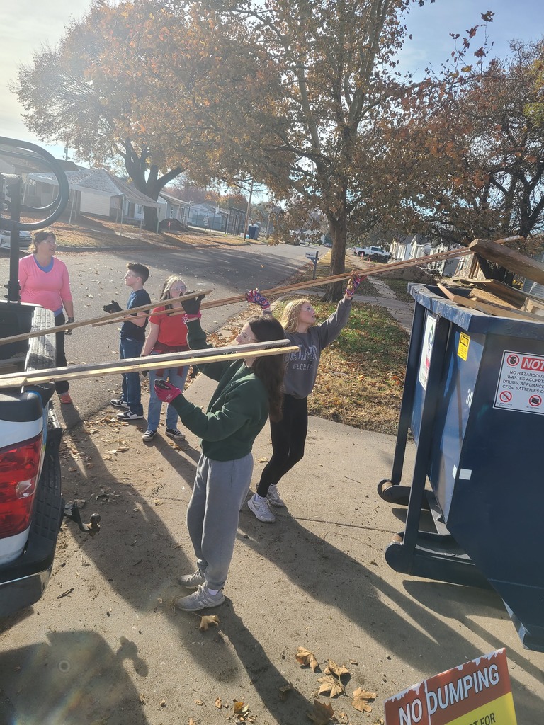 KAY Club students working with Habitat for Humanity - throwing away debris and hauling supplies
