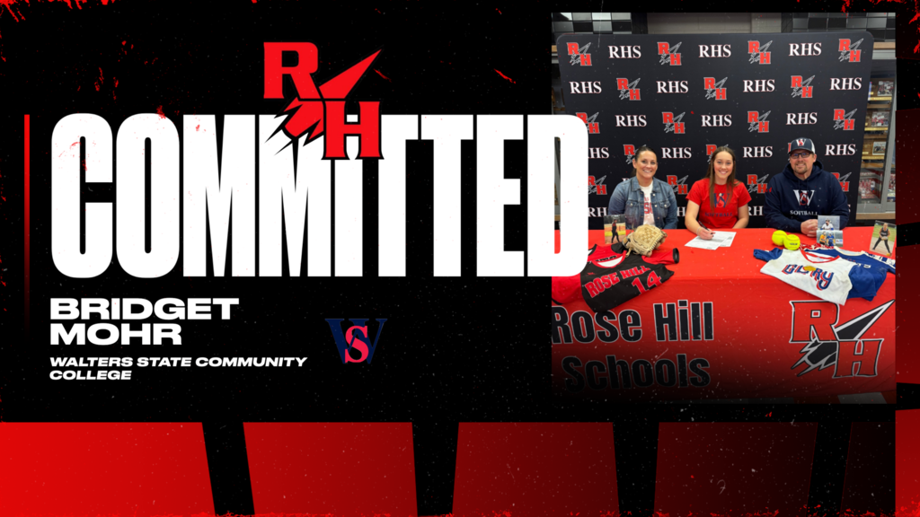 Bridget signing for softball with her parents sitting next to her.