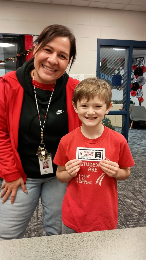 Little boy with his fuel-up coupon and principal in rocket pride gear