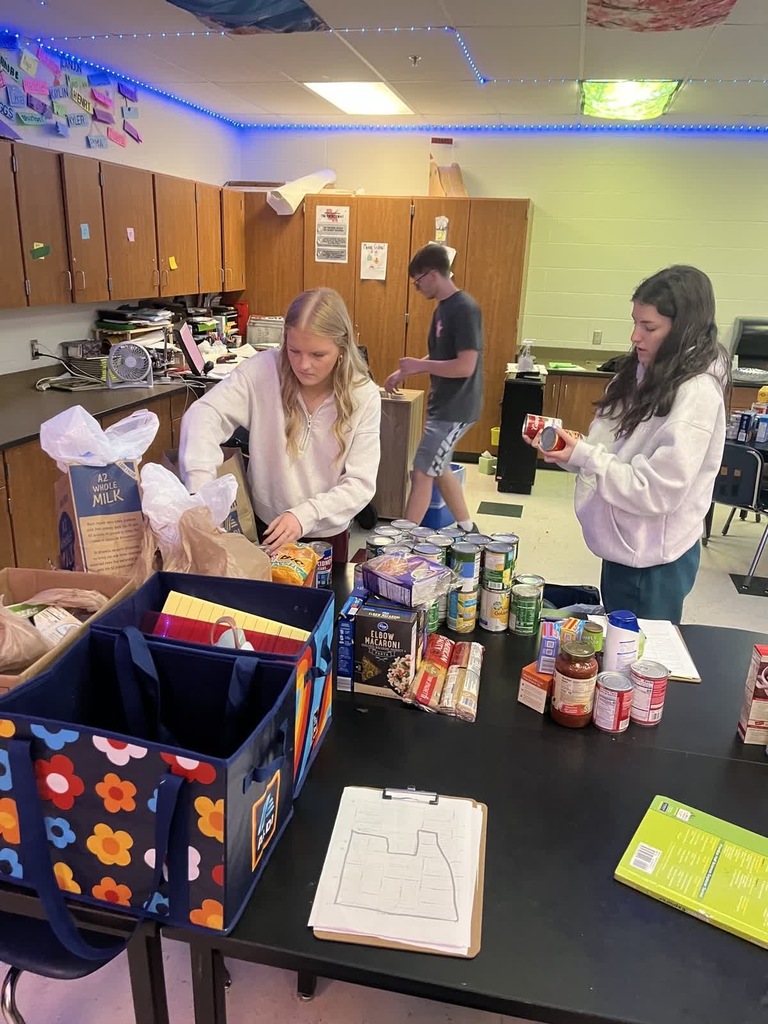 KAY Club Food Drive students packing up food