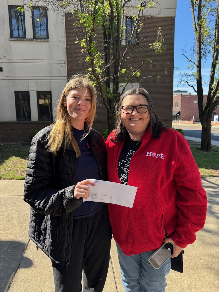 Student presenting check to Salvation Army