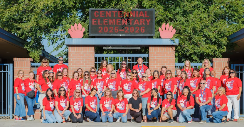 Teachers In Front of a sign