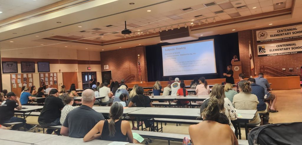 parents listening to a teacher's presentation