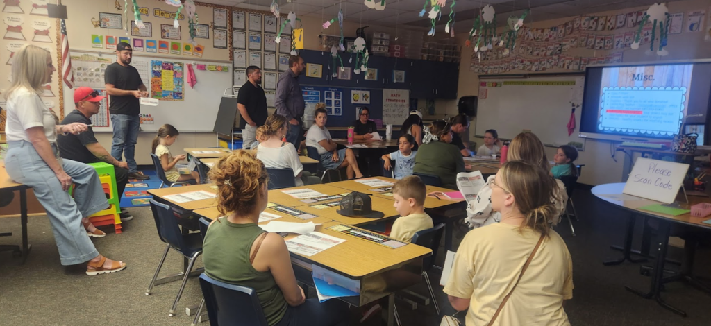 parents listening to a teacher's presentation