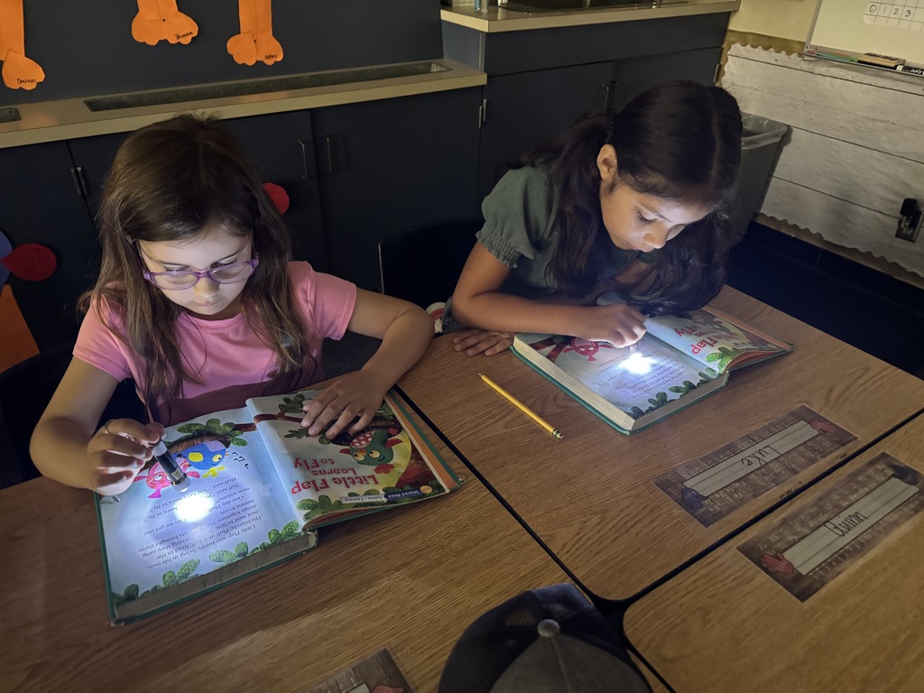 students reading with a flashlight