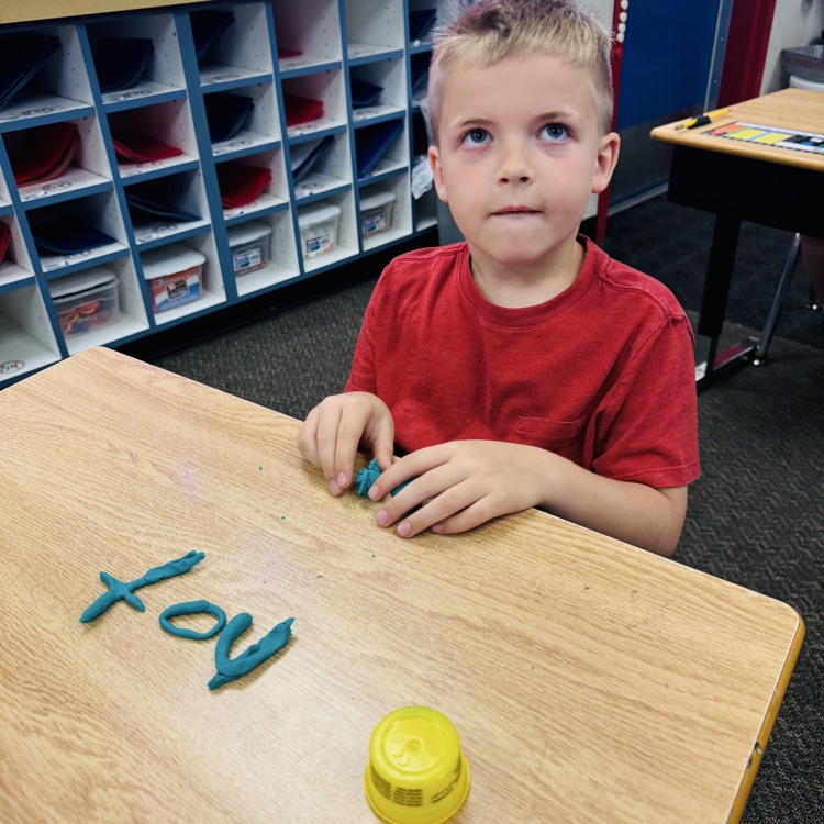 boy with word “not” shaped from playdoh 