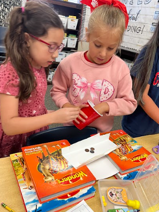 students building bridges out of paper and pennies
