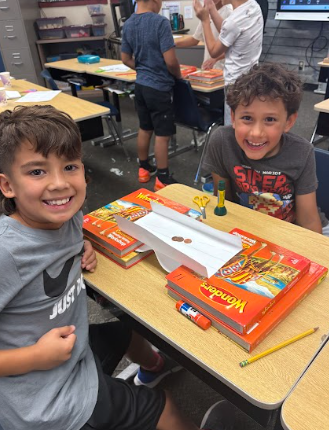 students building bridges out of paper and pennies