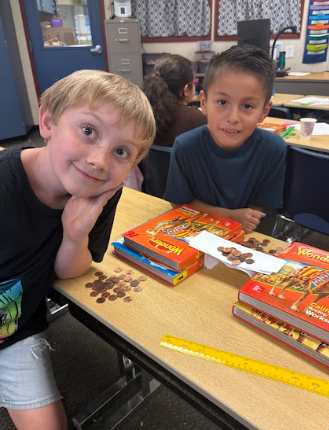 students building bridges out of paper and pennies